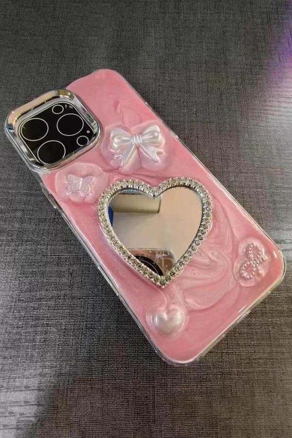 Caş Dekorasyon Pembe Renk Kalp Ve Kurdele Figürlü Aynalı 15 Pro Max Telefon Kılıfı - Image 1